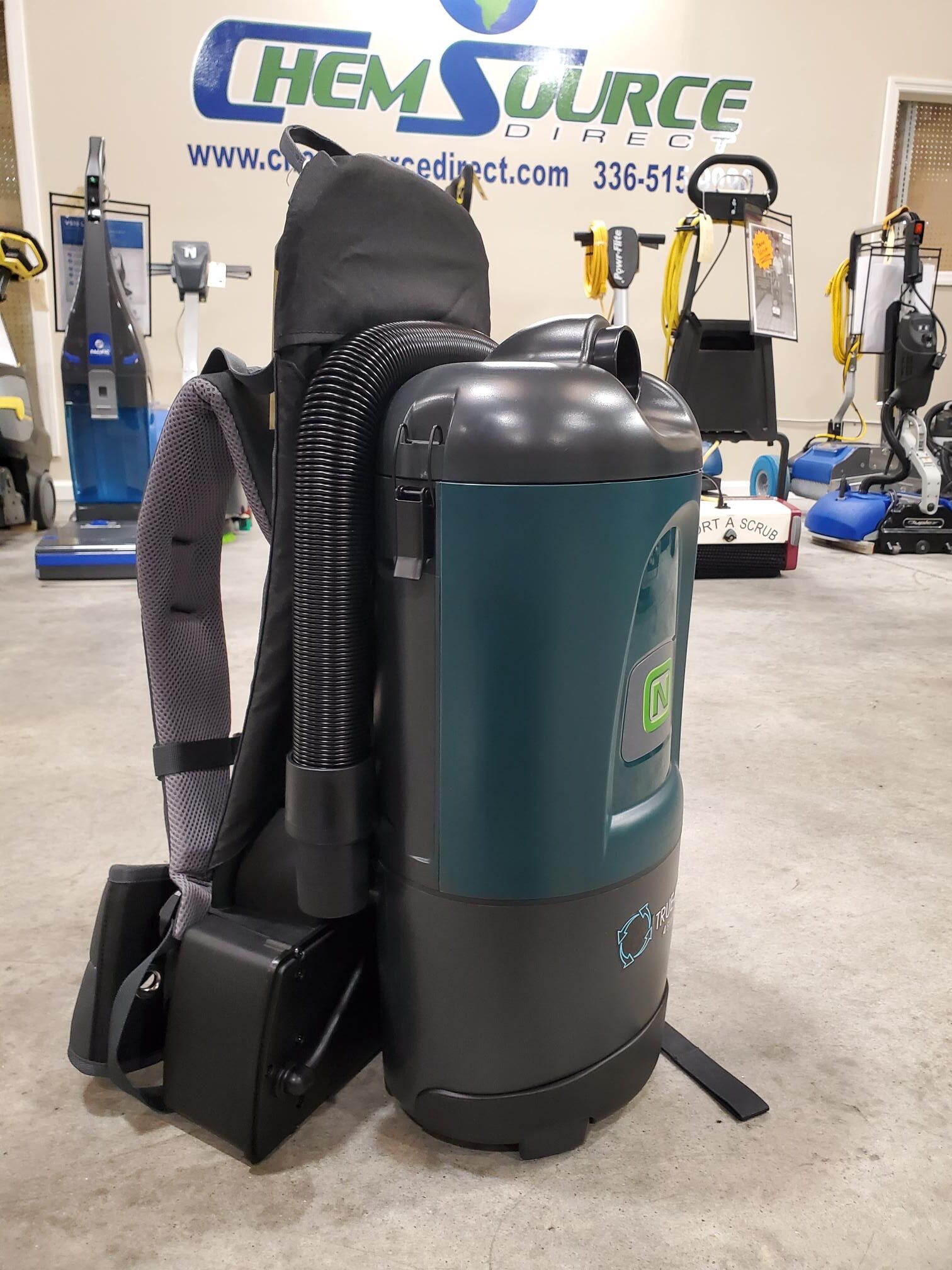 A backpack with the Nobles Aspen 6B 6qt Battery Powered Backpack Vacuum attached to it.