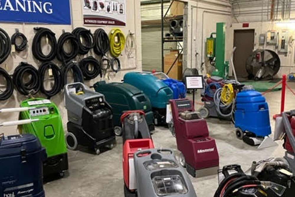 Many different types of vacuum cleaners in a warehouse.