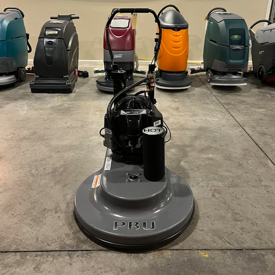 A group of floor scrubbers in a room.