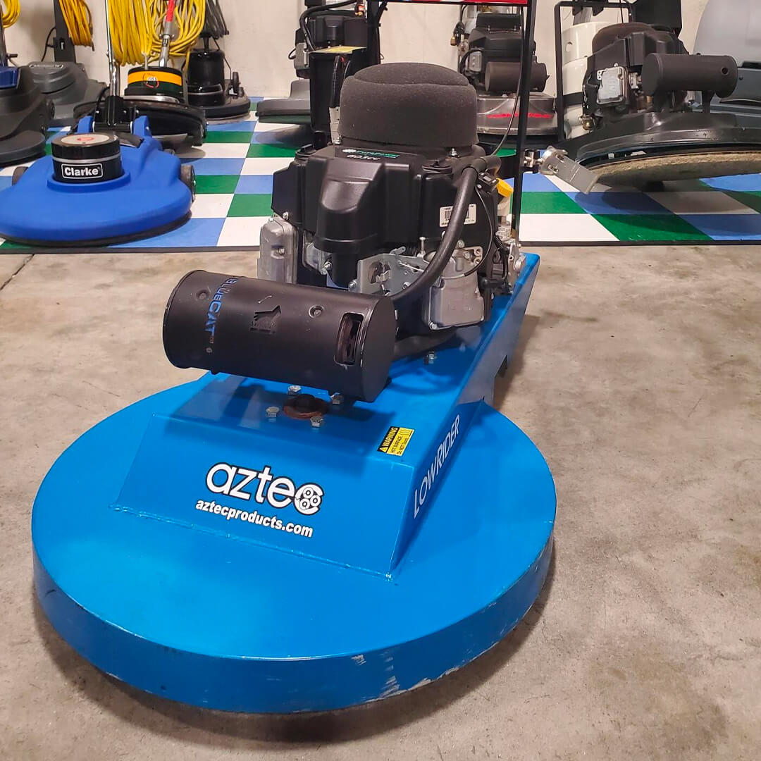 A blue machine is sitting on a floor in a store.