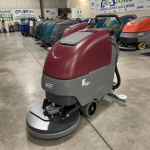 A NEW Minuteman E20BDQP 20" Scrubber Brush Drive stored in a warehouse.