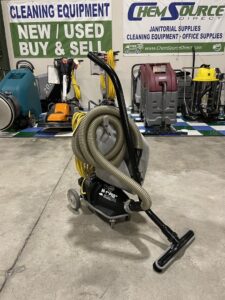 An NSS M1 Pig Heavy-Duty Canister Vacuum in a warehouse showroom.
