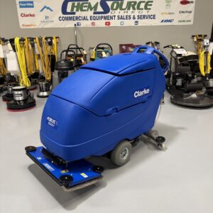 A Clarke Focus II Boost 28" Orbital Scrubber in a warehouse showroom at ChemSource Direct.