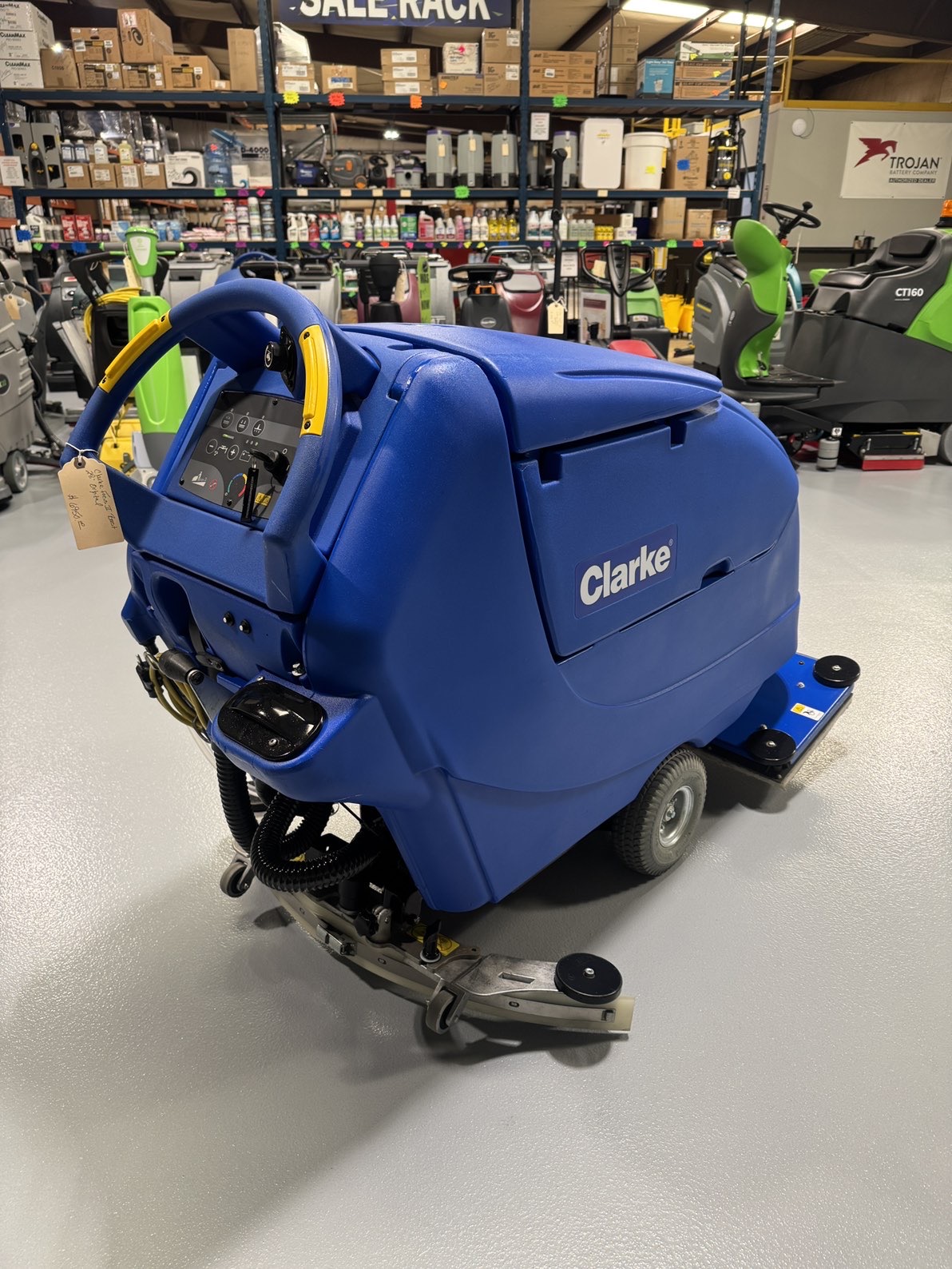A Clarke Focus II Boost 28" Orbital Scrubber in a warehouse showroom at ChemSource Direct.
