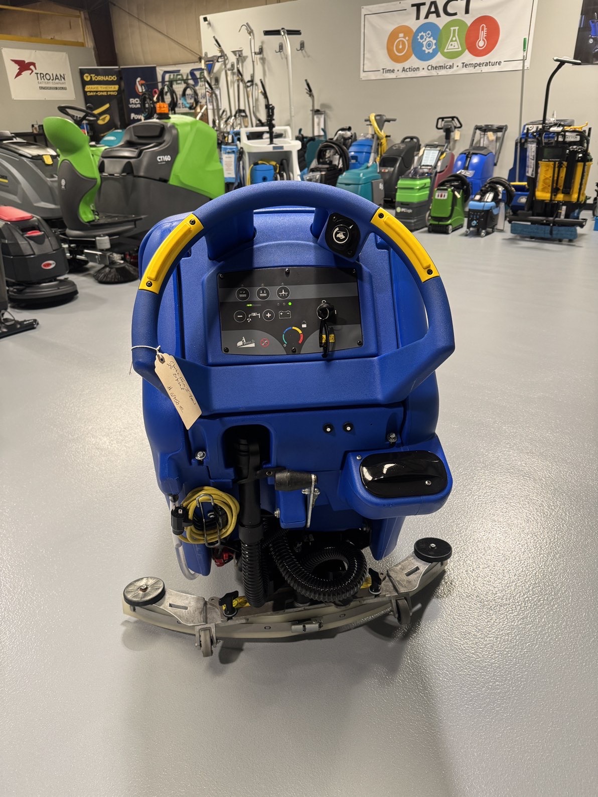 A Clarke Focus II Boost 28" Orbital Scrubber in a warehouse showroom at ChemSource Direct.