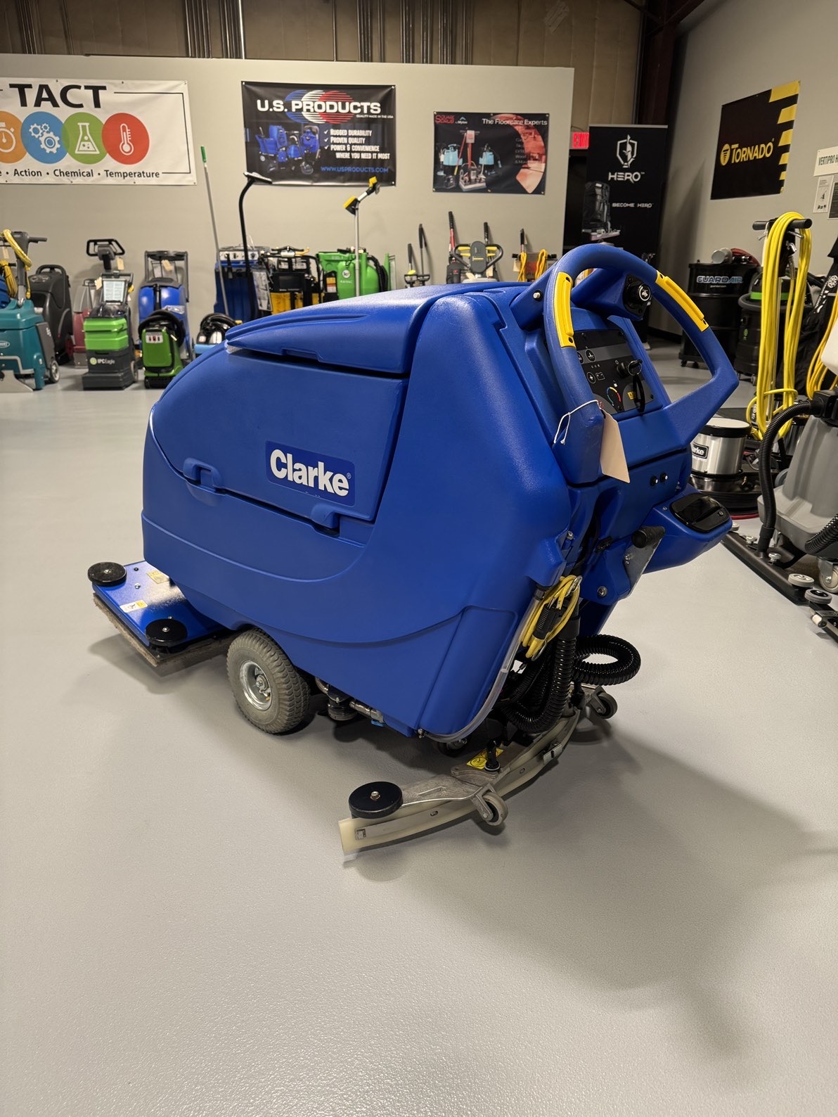 A Clarke Focus II Boost 28" Orbital Scrubber in a warehouse showroom at ChemSource Direct.