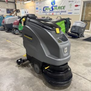 A Karcher B40 w BP Walk-Behind Scrubber in a warehouse showroom.
