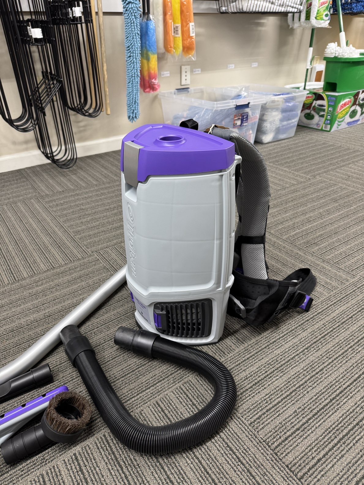 A ProTeam Go-Fit 6 Plus Back Pack Vacuum in a showroom.
