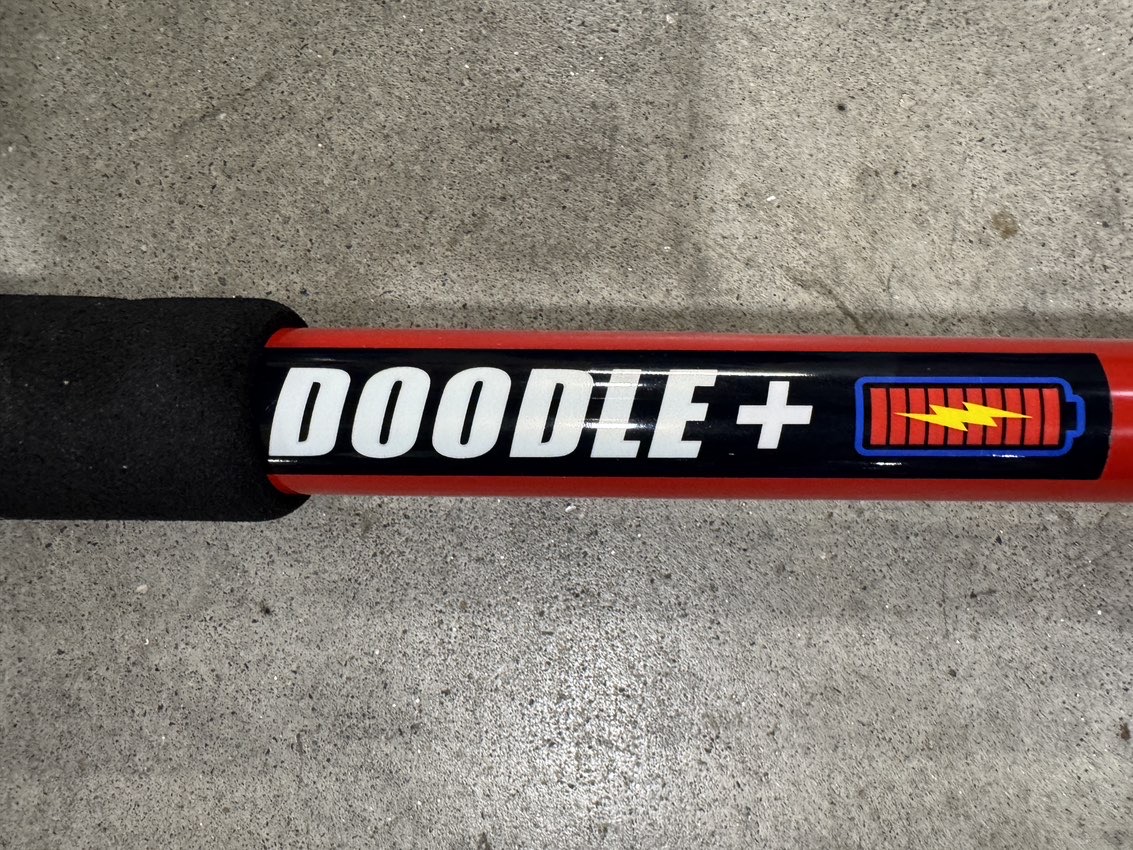 A Square Scrub Doodle Mop EBG-16-Batt in a warehouse showroom.