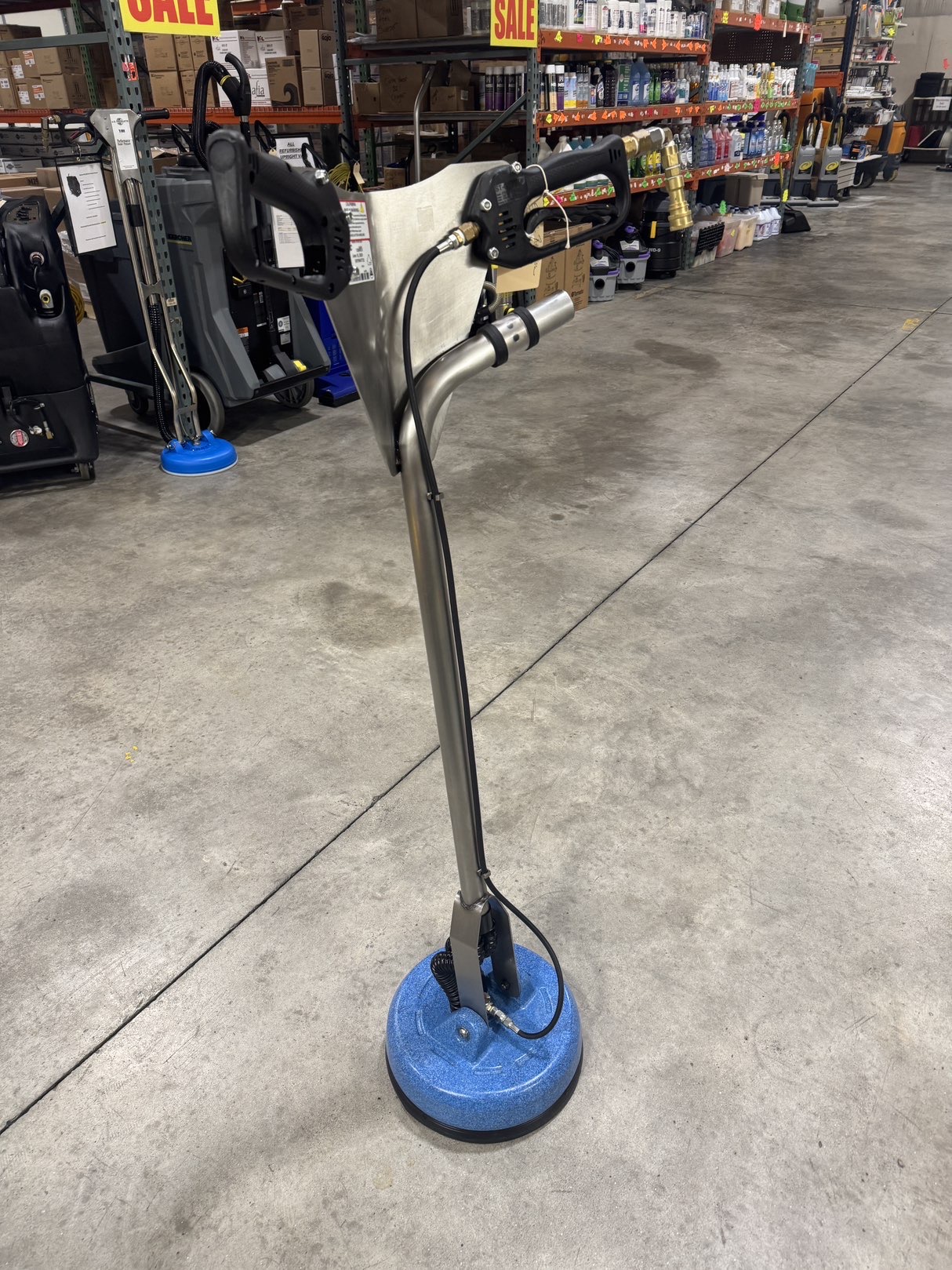 An EDIC Revolution Tile & Grout Tool in a warehouse showroom.