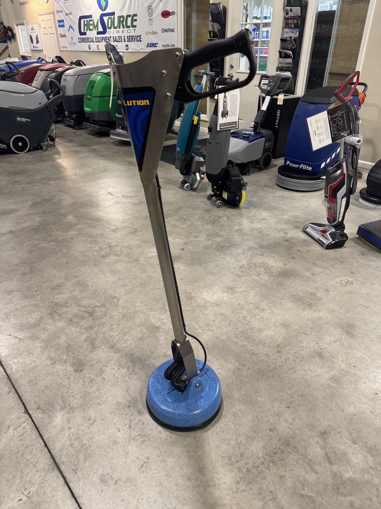 An EDIC Revolution Tile & Grout Tool in a warehouse showroom.