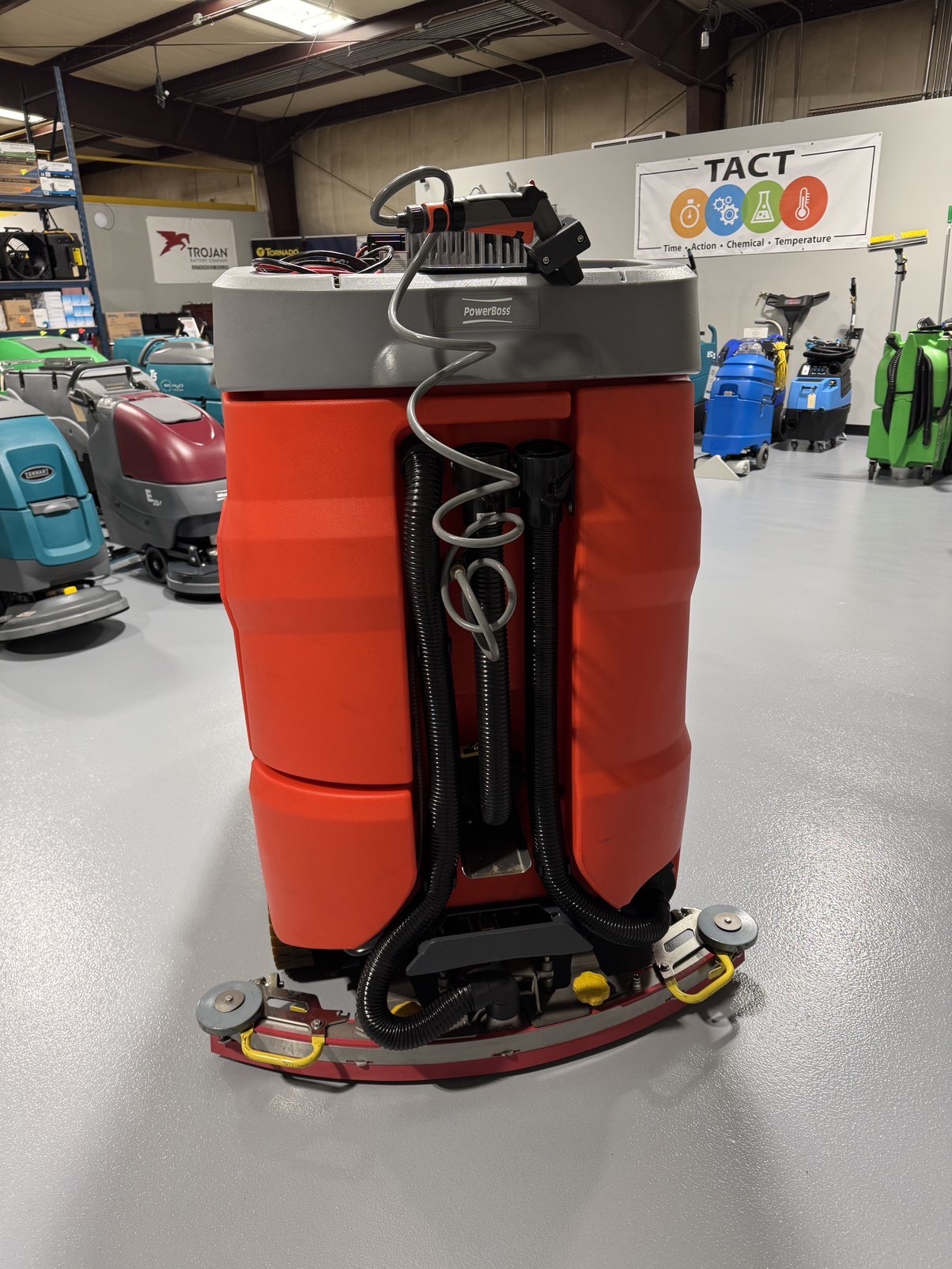 A PowerBoss Scrubmaster B175 Cylindrical Ride-On Scrubber in a warehouse showroom at ChemSource Direct.