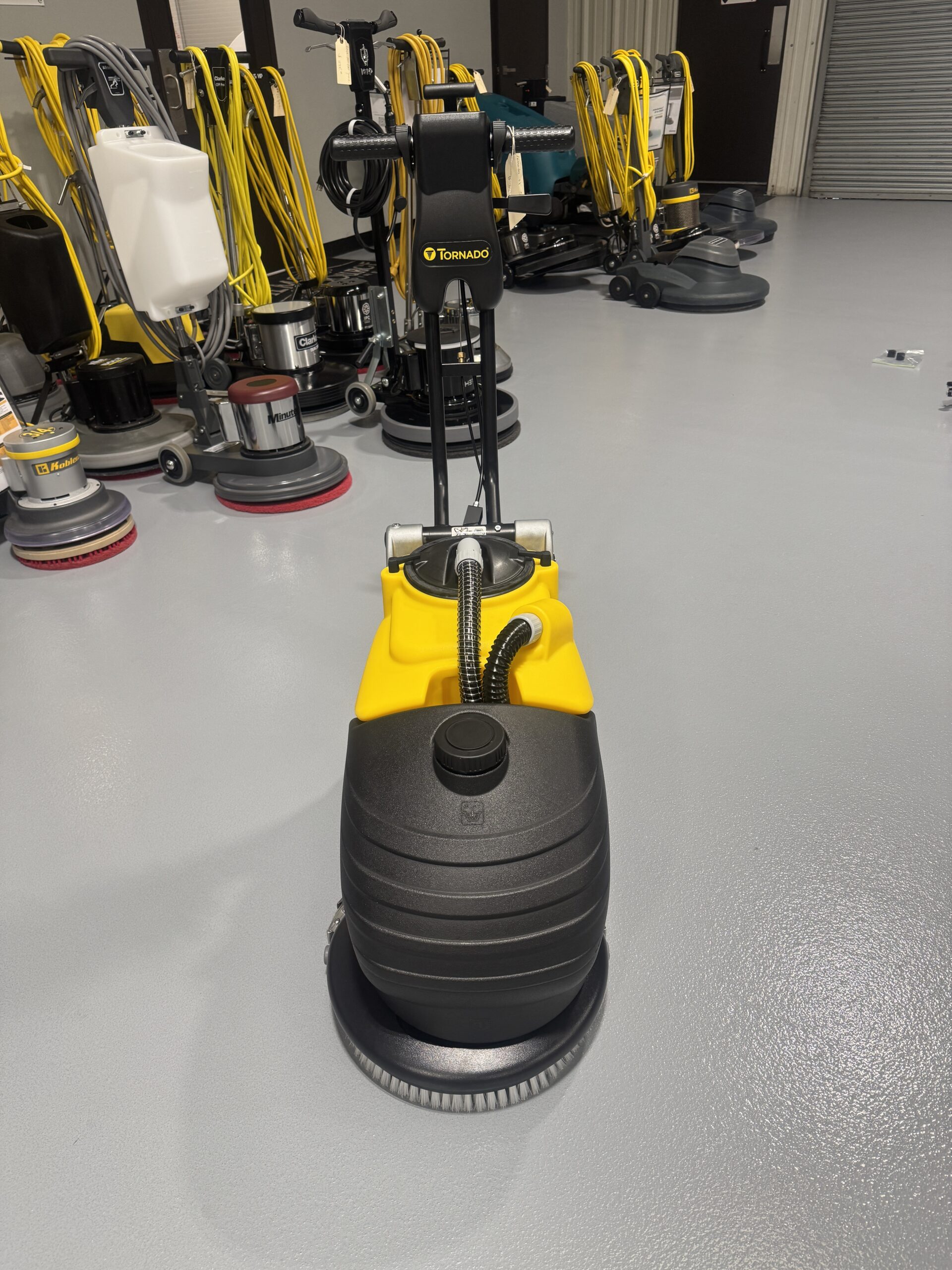 Tornado BD 14/4 14" Walk-Behind Scrubber in a warehouse showroom at ChemSource Direct.