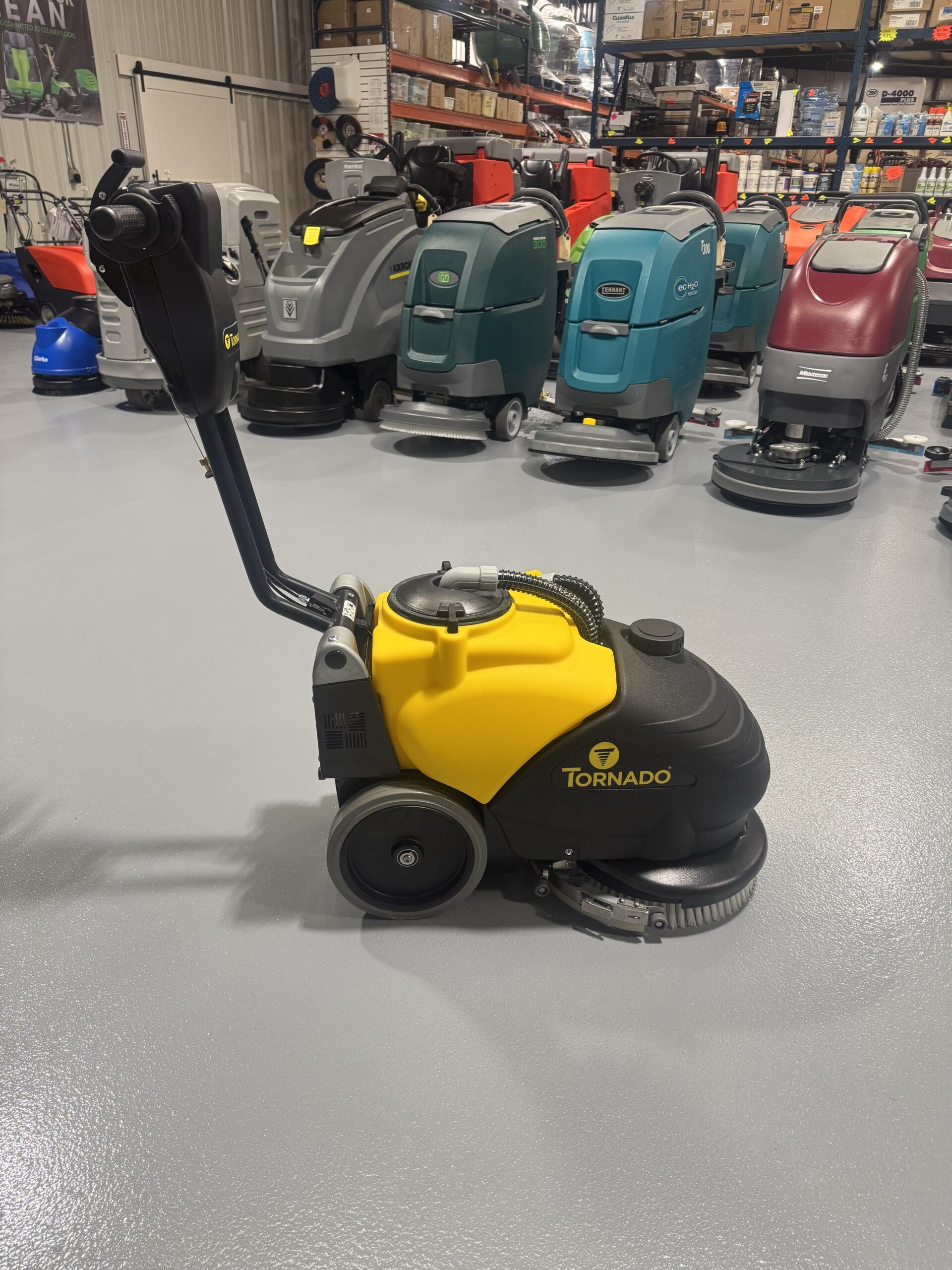 Tornado BD 14/4 14" Walk-Behind Scrubber in a warehouse showroom at ChemSource Direct.