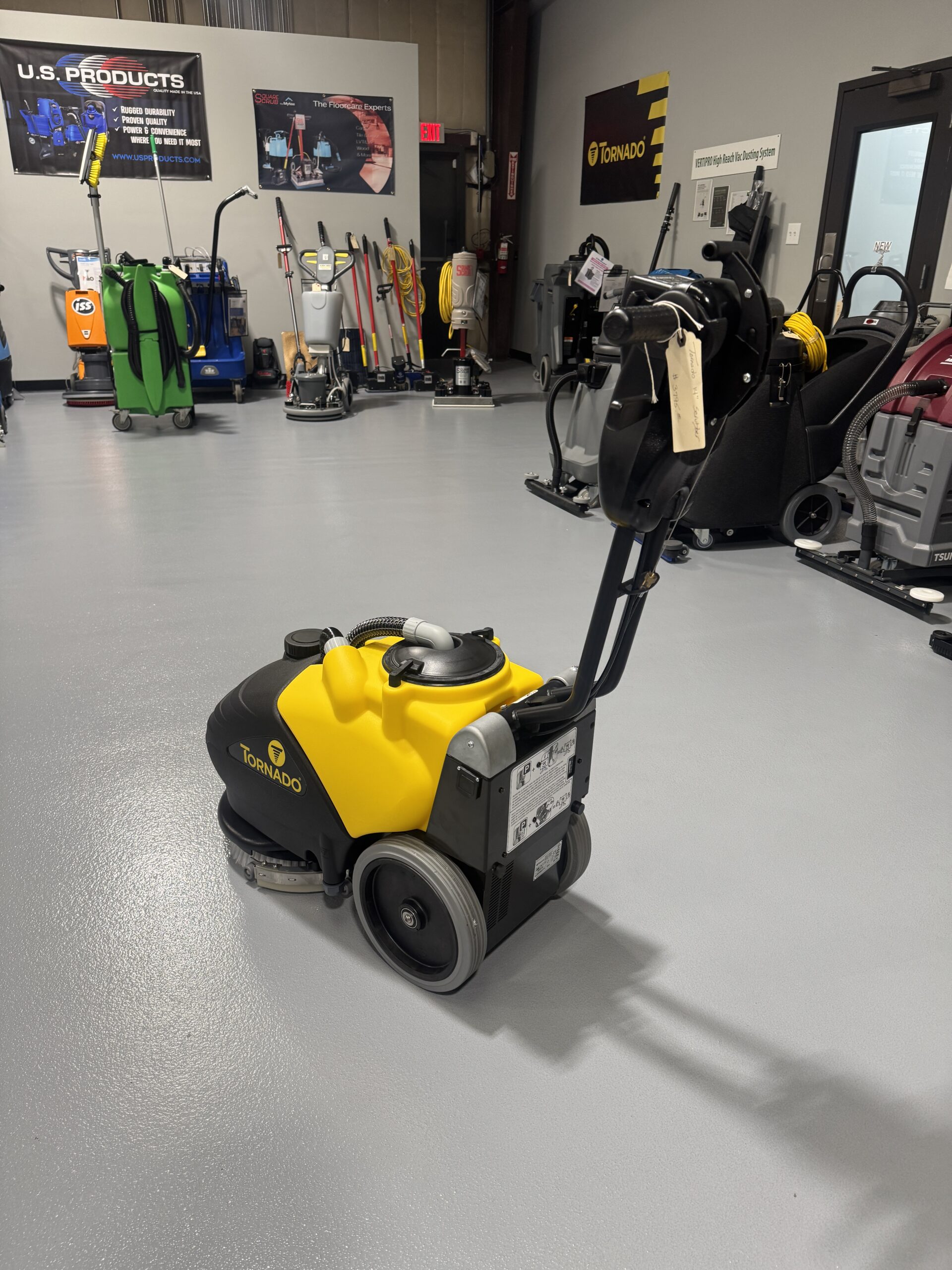 Tornado BD 14/4 14" Walk-Behind Scrubber in a warehouse showroom at ChemSource Direct.