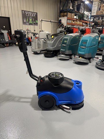 A Clarke MA50 15" Walk-Behind Scrubber in a warehouse showroom at ChemSource Direct.