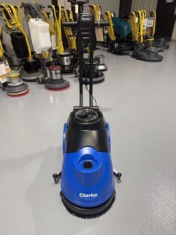 A Clarke MA50 15" Walk-Behind Scrubber in a warehouse showroom at ChemSource Direct.