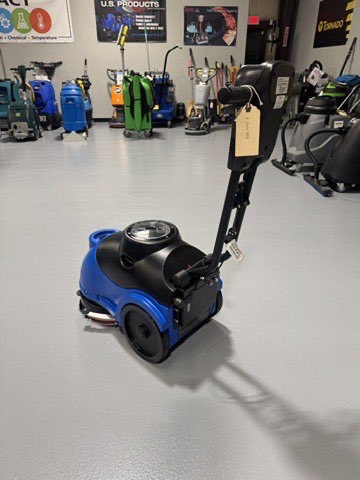 A Clarke MA50 15" Walk-Behind Scrubber in a warehouse showroom at ChemSource Direct.