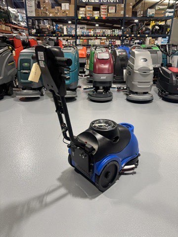 A Clarke MA50 15" Walk-Behind Scrubber in a warehouse showroom at ChemSource Direct.