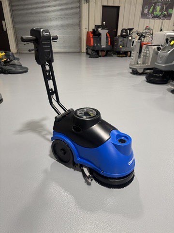 A Clarke MA50 15" Walk-Behind Scrubber in a warehouse showroom at ChemSource Direct.
