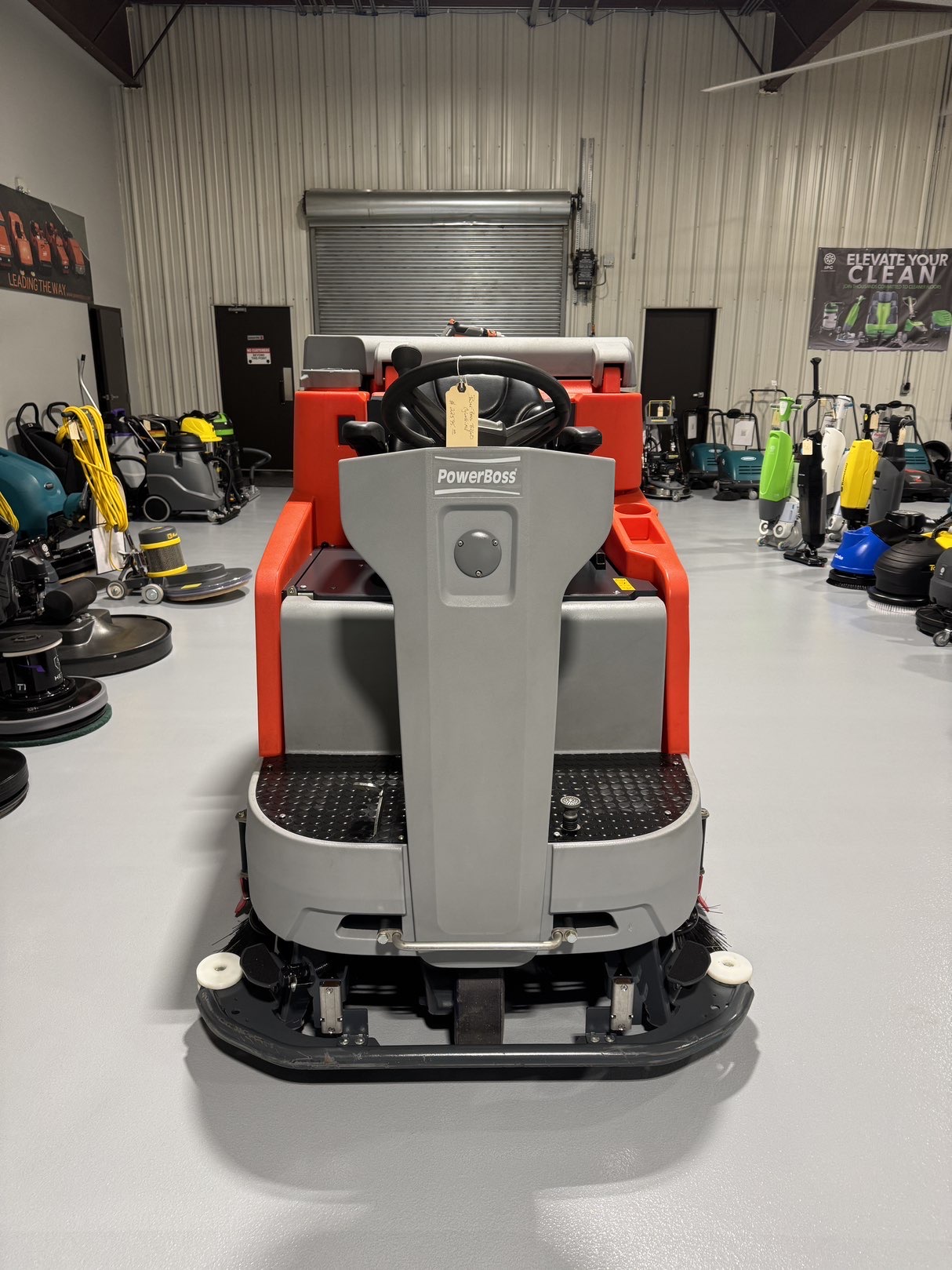 A Powerboss B260R Cylindrical Ride-On Scrubber in a warehouse showroom at ChemSource Direct.