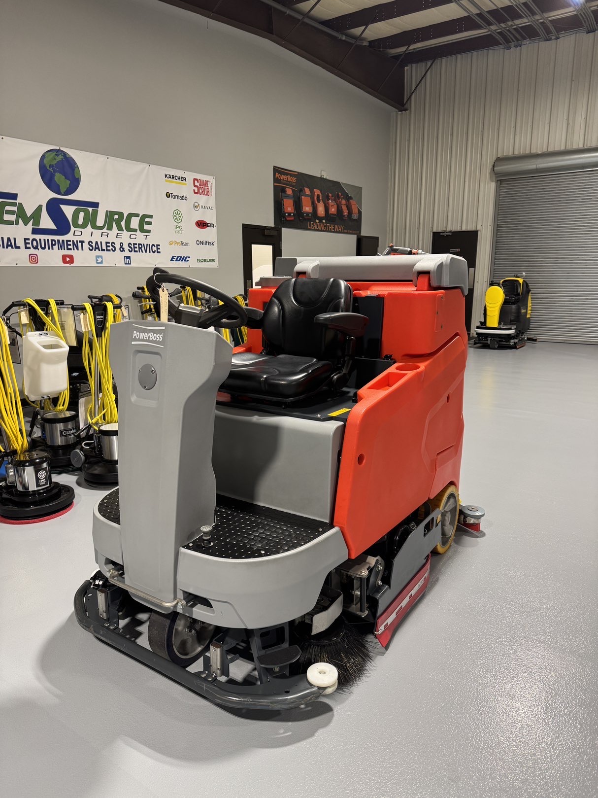 A Powerboss B260R Cylindrical Ride-On Scrubber in a warehouse showroom at ChemSource Direct.