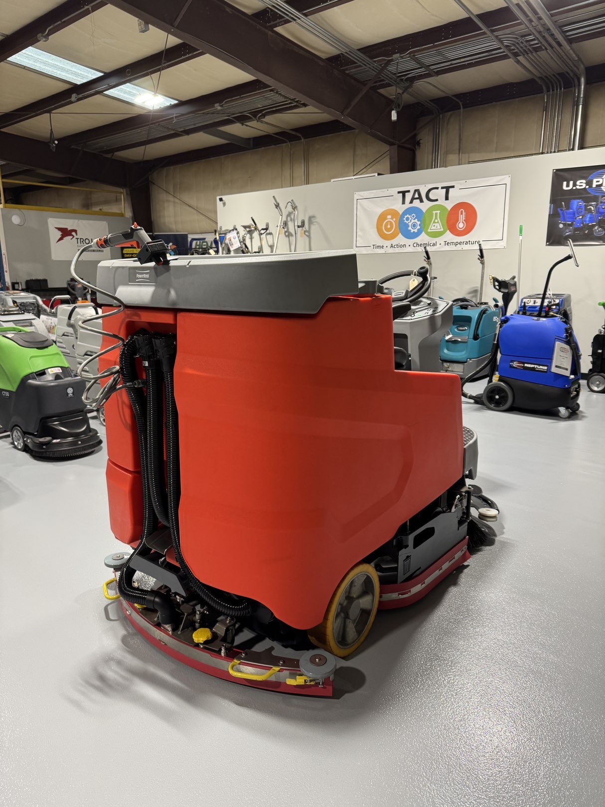 A Powerboss B260R Cylindrical Ride-On Scrubber in a warehouse showroom at ChemSource Direct.