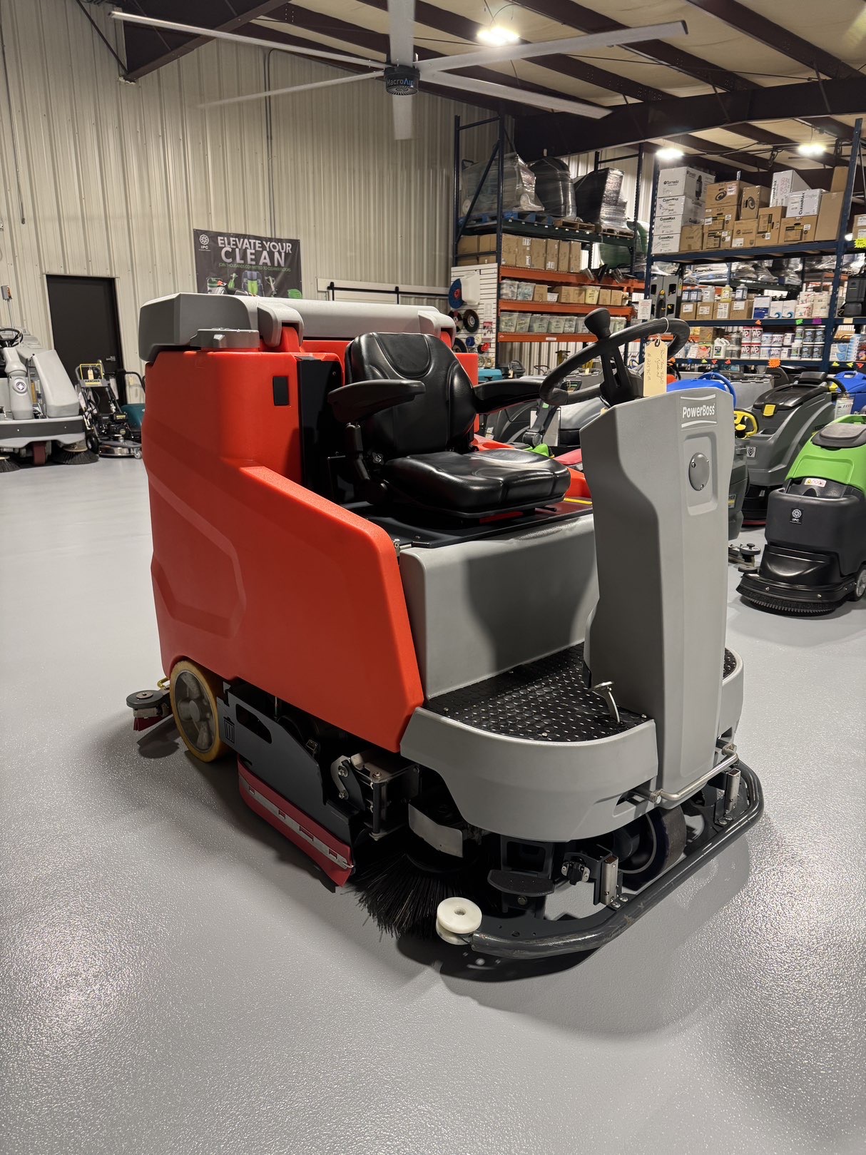 A Powerboss B260R Cylindrical Ride-On Scrubber in a warehouse showroom at ChemSource Direct.