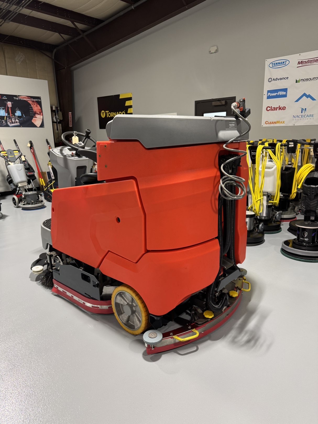A Powerboss B260R Cylindrical Ride-On Scrubber in a warehouse showroom at ChemSource Direct.