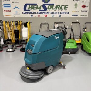 A Tennant T300 Walk-Behind Scrubber in a warehouse showroom at ChemSource Direct.