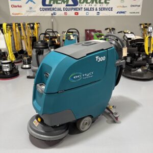 A Tennant T300 Walk-Behind Scrubber in a warehouse showroom at ChemSource Direct.