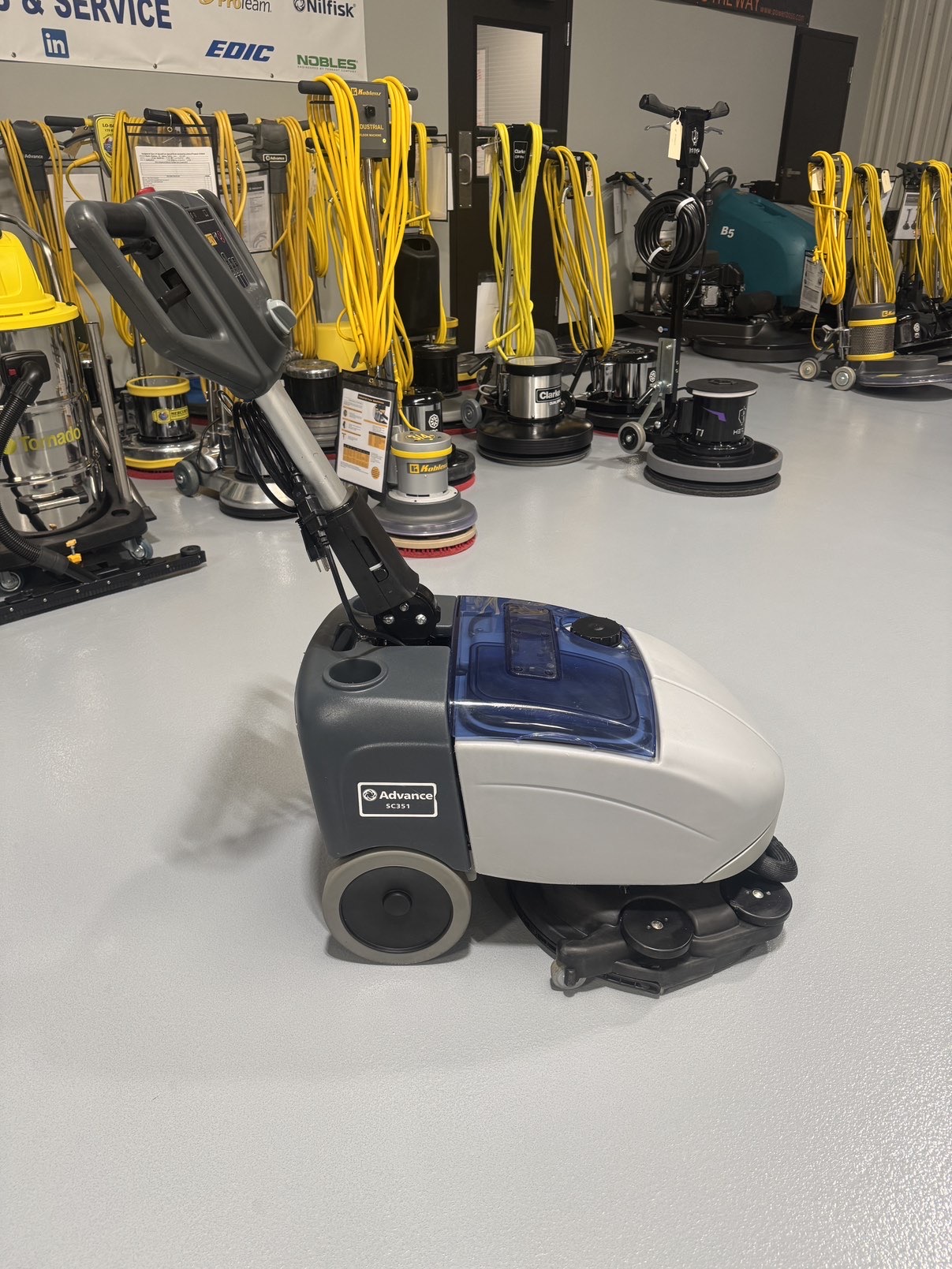 Advance SC351 Walk-Behind Scrubber in a warehouse showroom at ChemSource Direct.