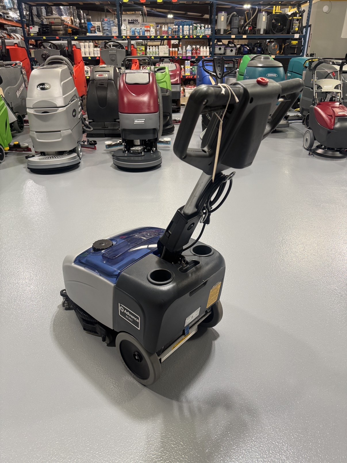 Advance SC351 Walk-Behind Scrubber in a warehouse showroom at ChemSource Direct.