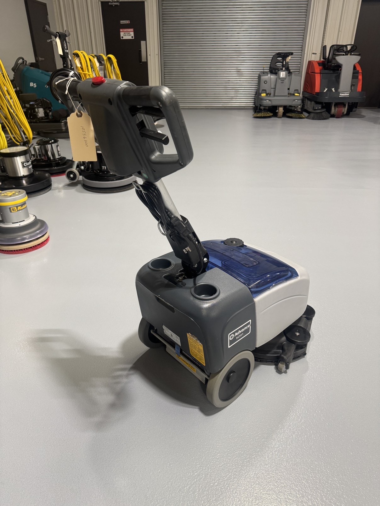 Advance SC351 Walk-Behind Scrubber in a warehouse showroom at ChemSource Direct.