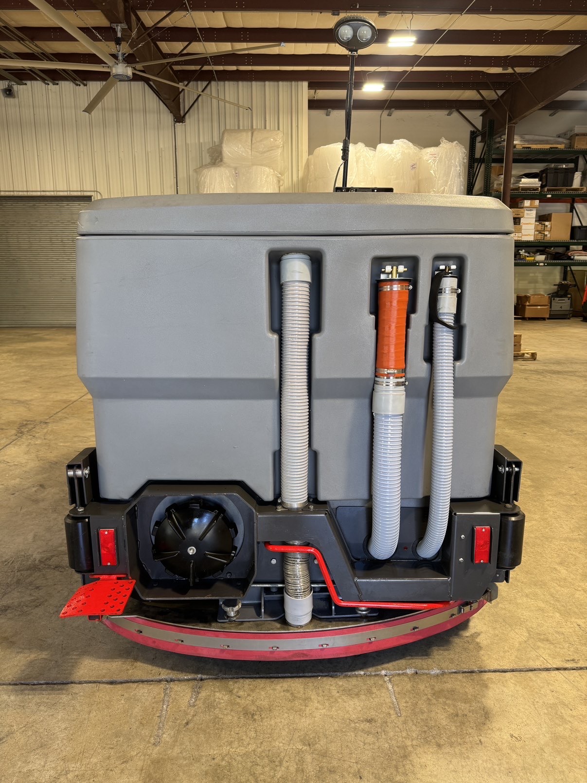 A Powerboss Nautilus PB45LP Ride-On Scrubber in a warehouse showroom at ChemSource Direct.