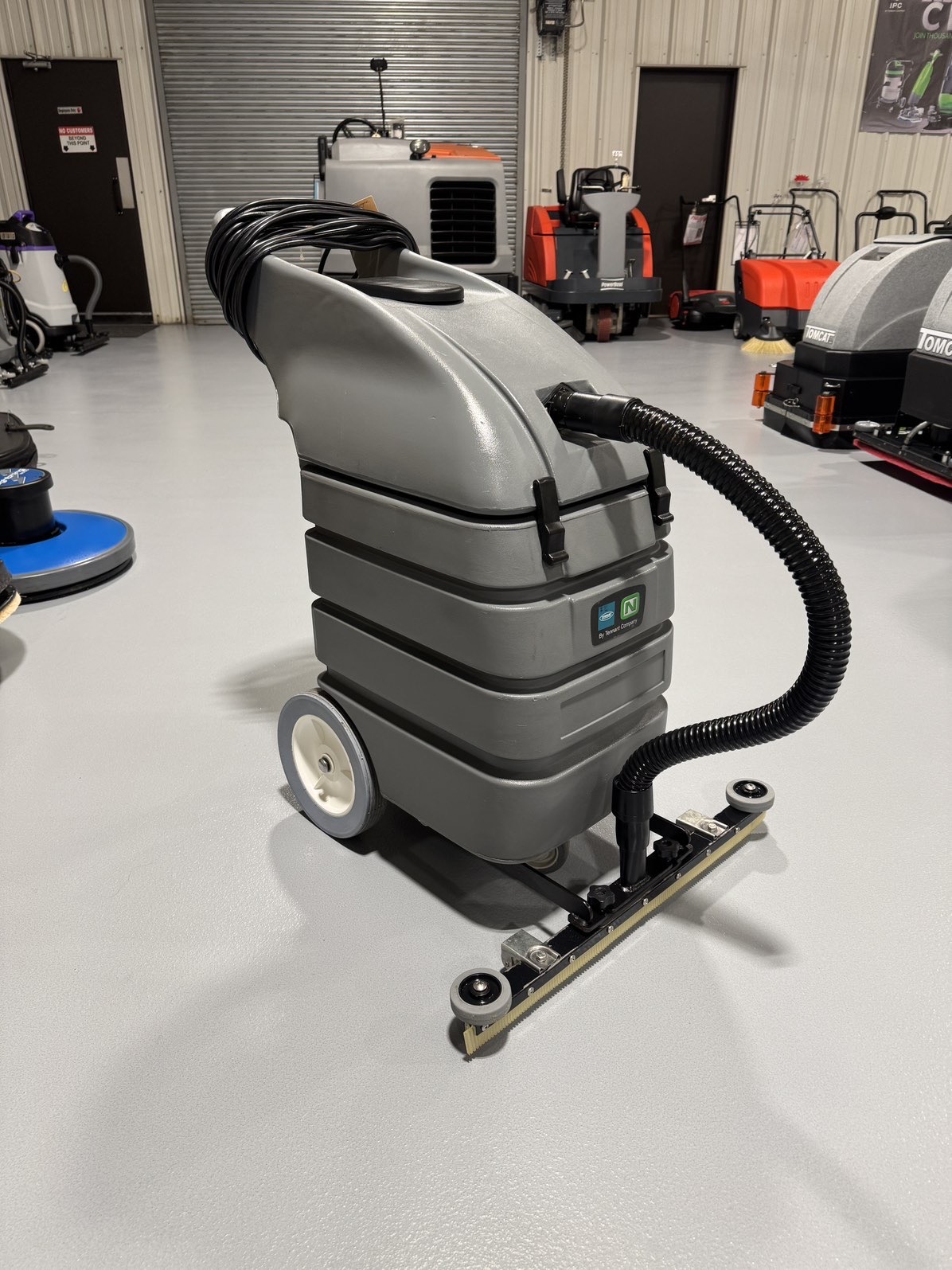 A Tennant V-WD-15 15 Gallon Wet/Dry Vacuum in a warehouse showroom at ChemSource Direct.
