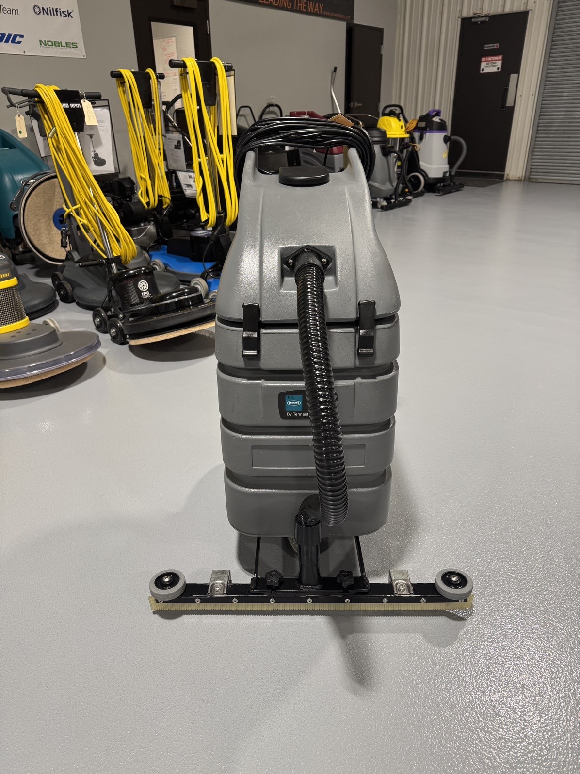 A Tennant V-WD-15 15 Gallon Wet/Dry Vacuum in a warehouse showroom at ChemSource Direct.