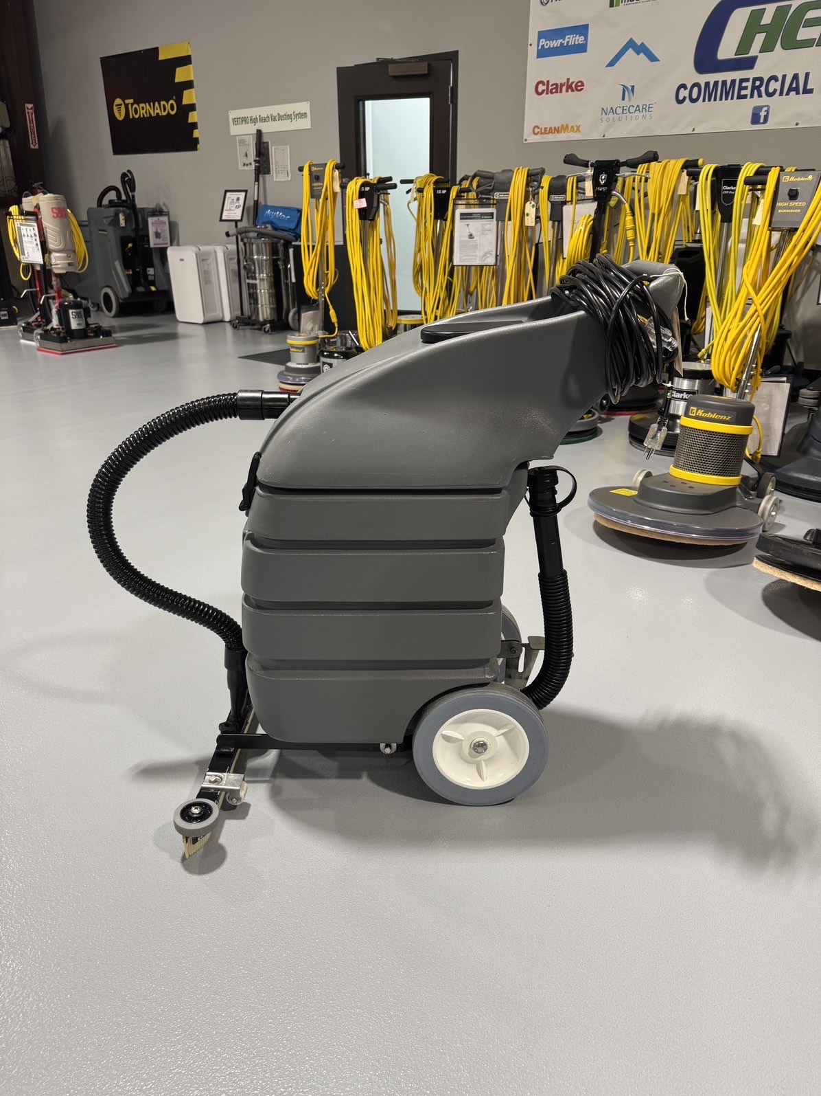 A Tennant V-WD-15 15 Gallon Wet/Dry Vacuum in a warehouse showroom at ChemSource Direct.