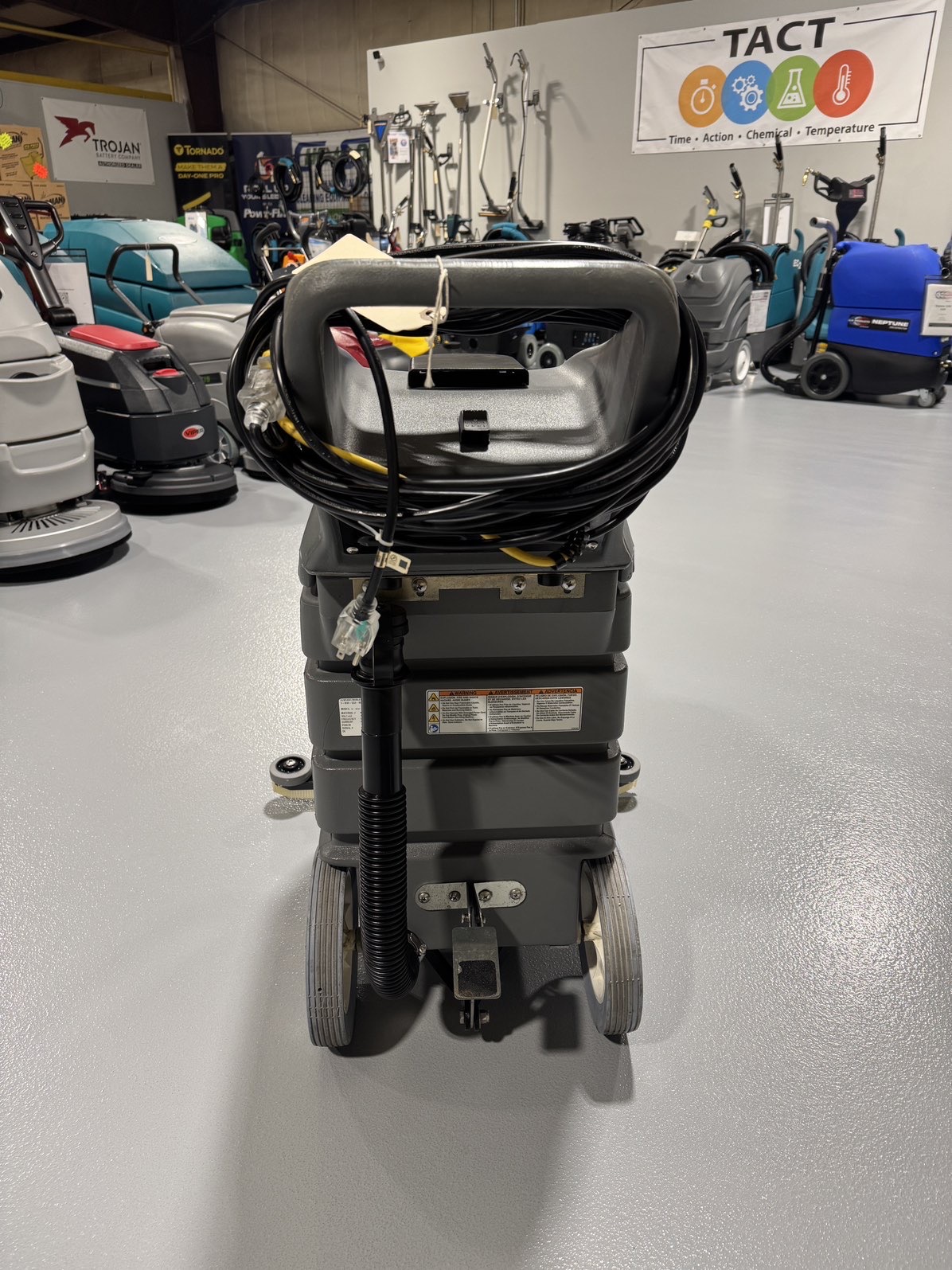 A Tennant V-WD-15 15 Gallon Wet/Dry Vacuum in a warehouse showroom at ChemSource Direct.