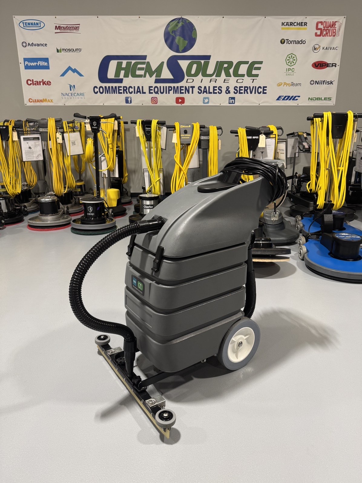 A Tennant V-WD-15 15 Gallon Wet/Dry Vacuum in a warehouse showroom at ChemSource Direct.