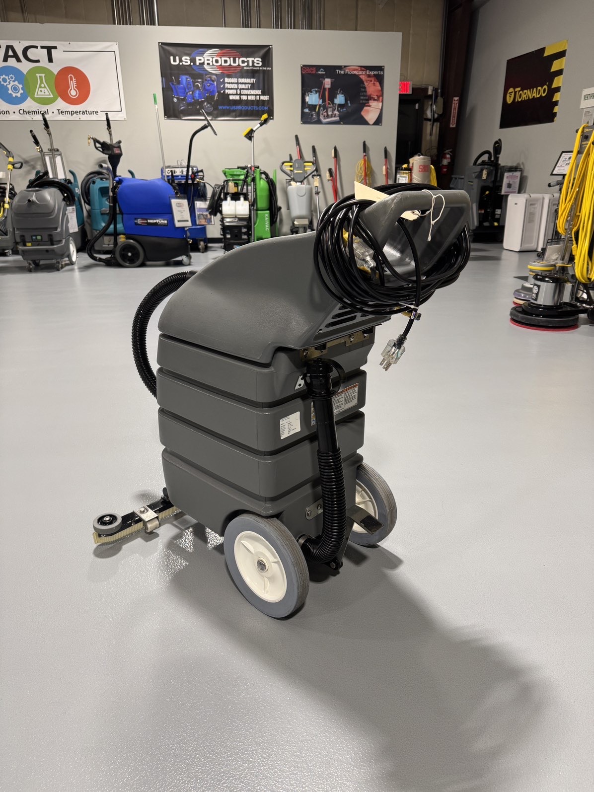 A Tennant V-WD-15 15 Gallon Wet/Dry Vacuum in a warehouse showroom at ChemSource Direct.