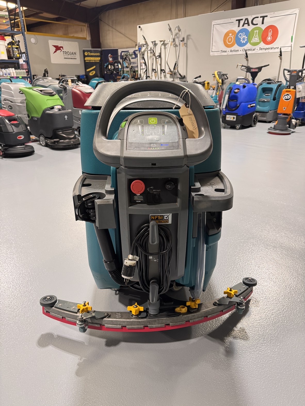 A Tennant T500 Walk-Behind Scrubber in a warehouse showroom at ChemSource Direct.