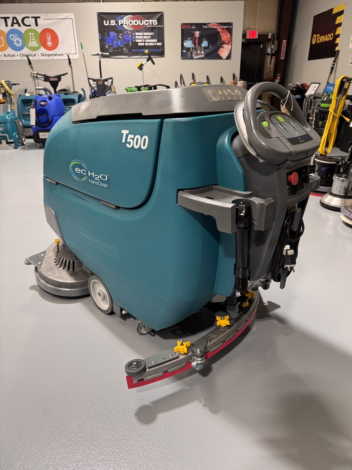 A Tennant T500 Walk-Behind Scrubber in a warehouse showroom at ChemSource Direct.