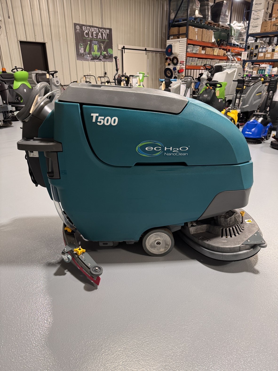 A Tennant T500 Walk-Behind Scrubber in a warehouse showroom at ChemSource Direct.