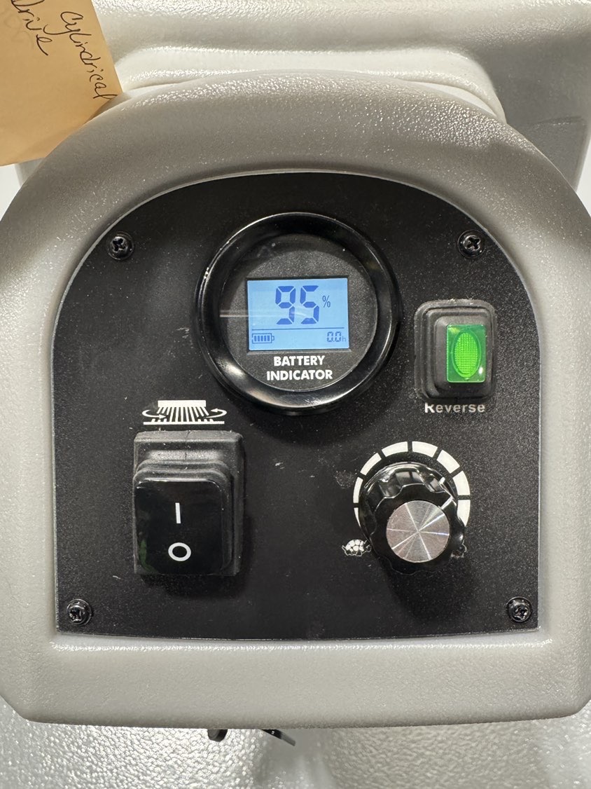 An Onyx DX20C Cylindrical Walk-Behind Scrubber in a warehouse showroom at ChemSource Direct.