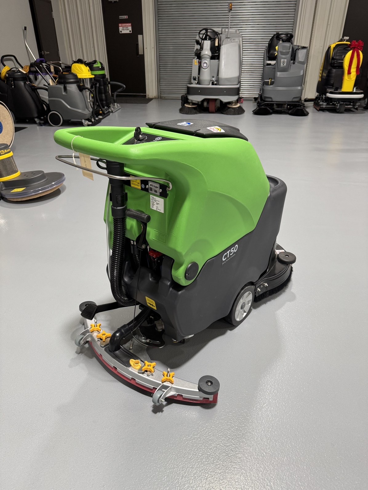 An IPC CT50 Walk-Behind Scrubber in a warehouse showroom at ChemSource Direct.