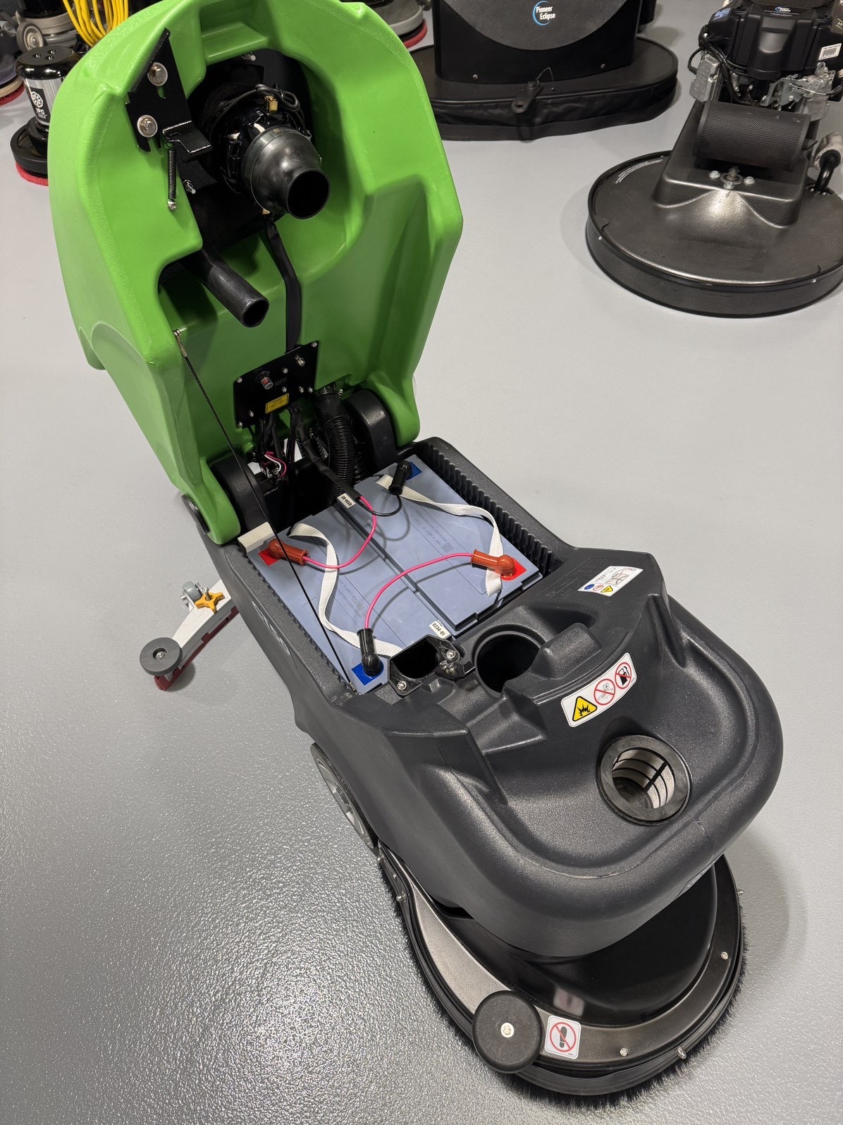 An IPC CT50 Walk-Behind Scrubber in a warehouse showroom at ChemSource Direct.
