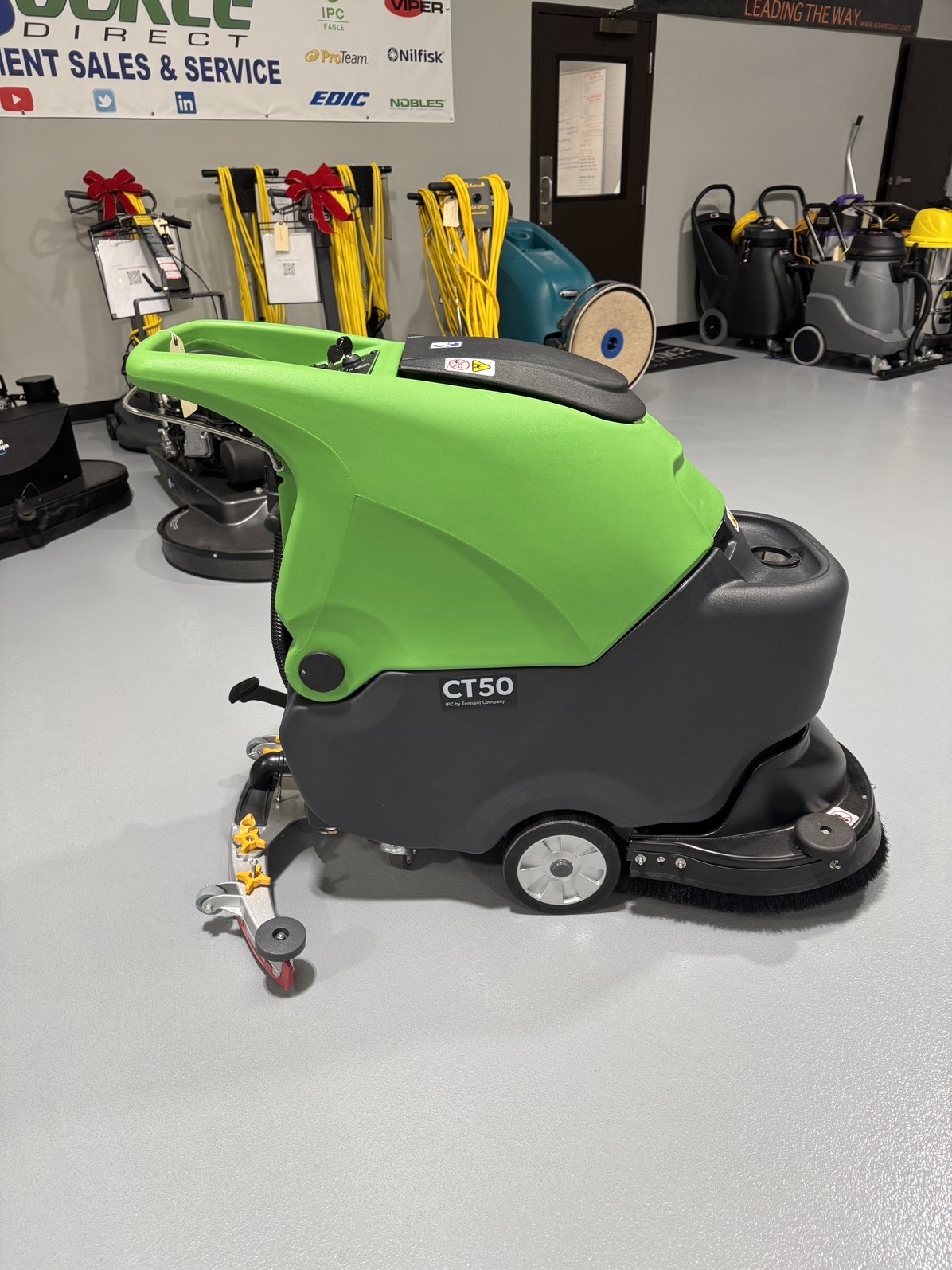 An IPC CT50 Walk-Behind Scrubber in a warehouse showroom at ChemSource Direct.