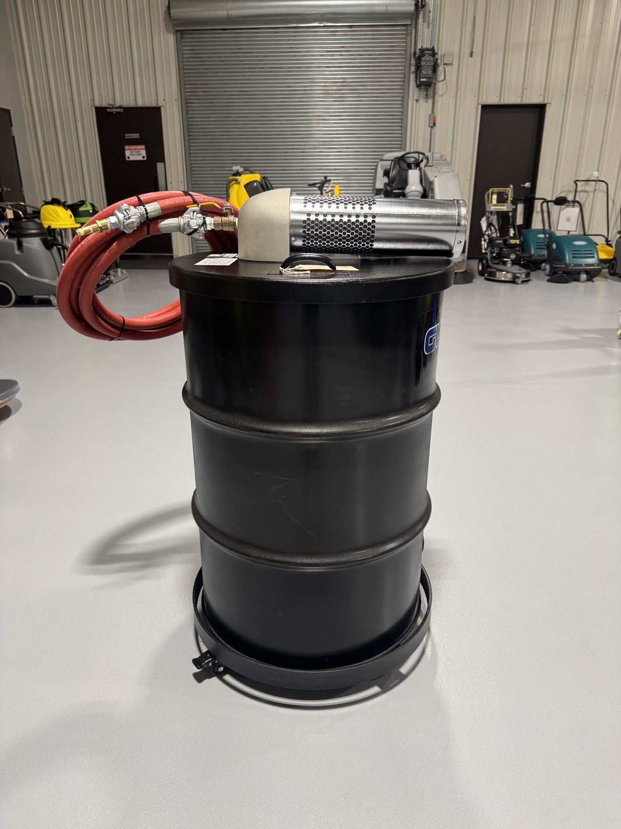 A Guardair Single Venturi 55 Gallon Wet/Dry Vac in a warehouse showroom at ChemSource Direct.