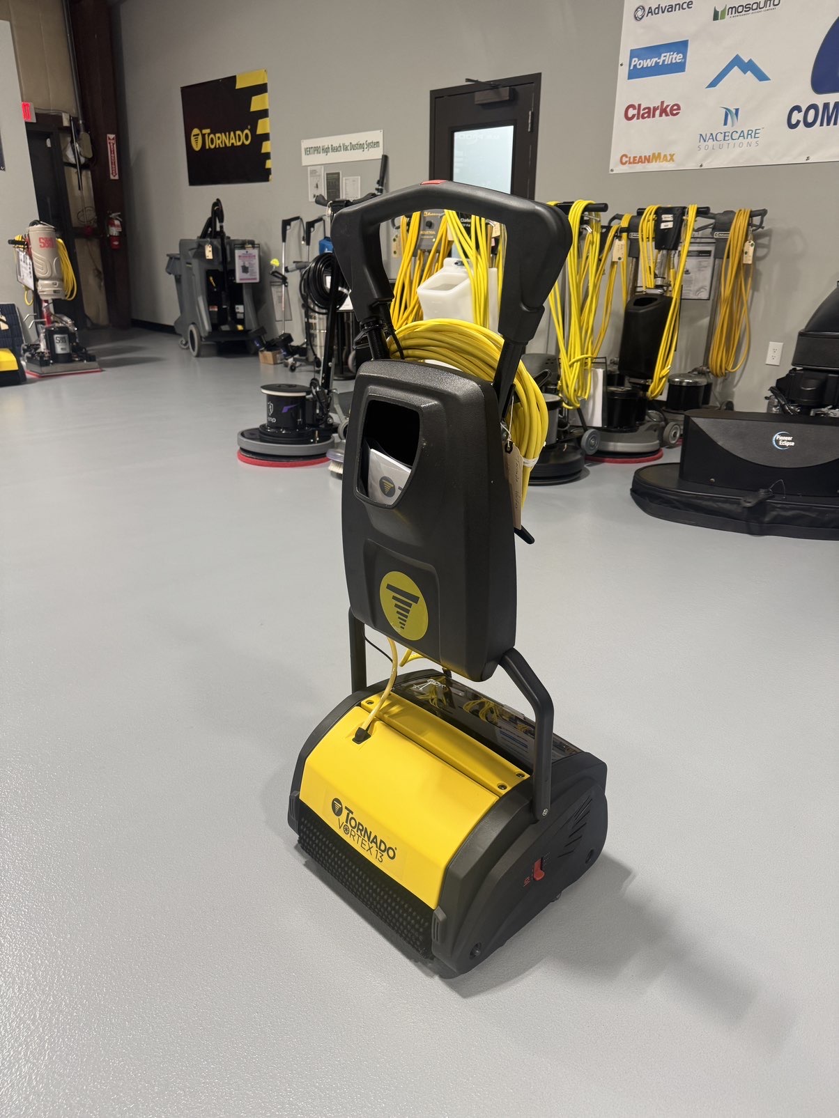 A Tornado Vortex 13 Cylindrical Floor Scrubber in a warehouse showroom at ChemSource Direct.